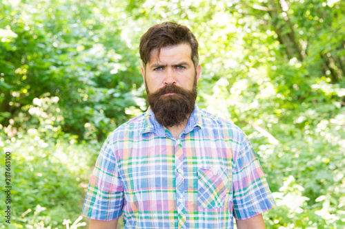 Brutal style trends. Bearded man with brutal look on natural landscape. Caucasian guy with long brutal beard and mustache on summer nature. Brutal hipster wearing casual style outdoor © be free