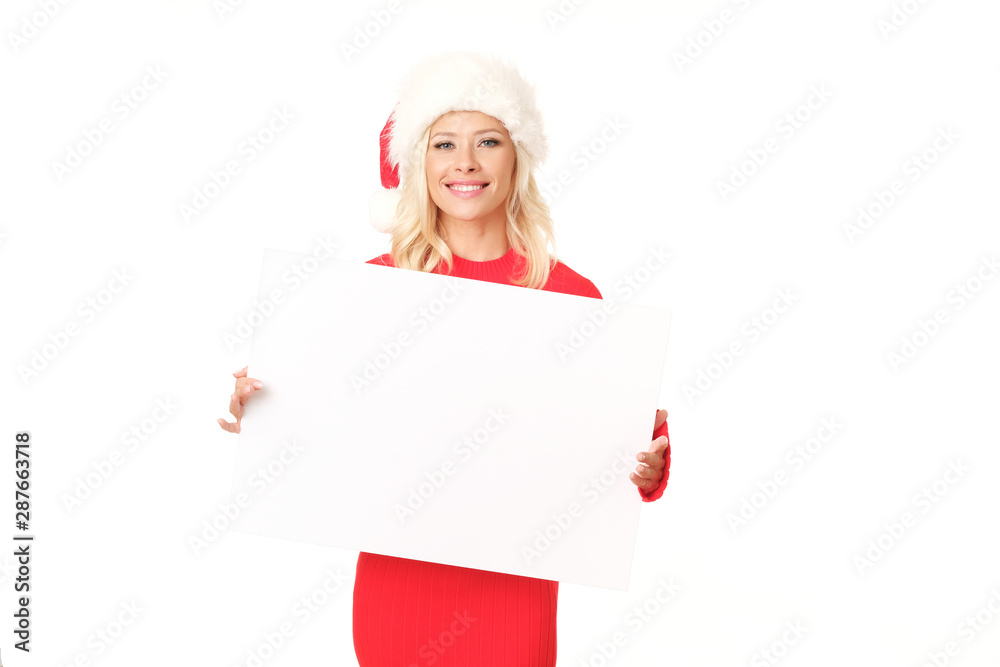 Cute blonde woman wearing santa hat is posing with white board. Cute blonde woman wearing santa hat is posing with white board.