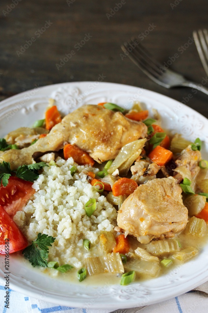 keto dish. Chicken with Cauliflower Rice. low carbohydrates a lot of protein. stewed chicken with celery and carrots in a white plate. keto dish. Chicken with Cauliflower Rice. low carbohydrates a lot of protein. stewed chicken with celery and carrots in a white plate.