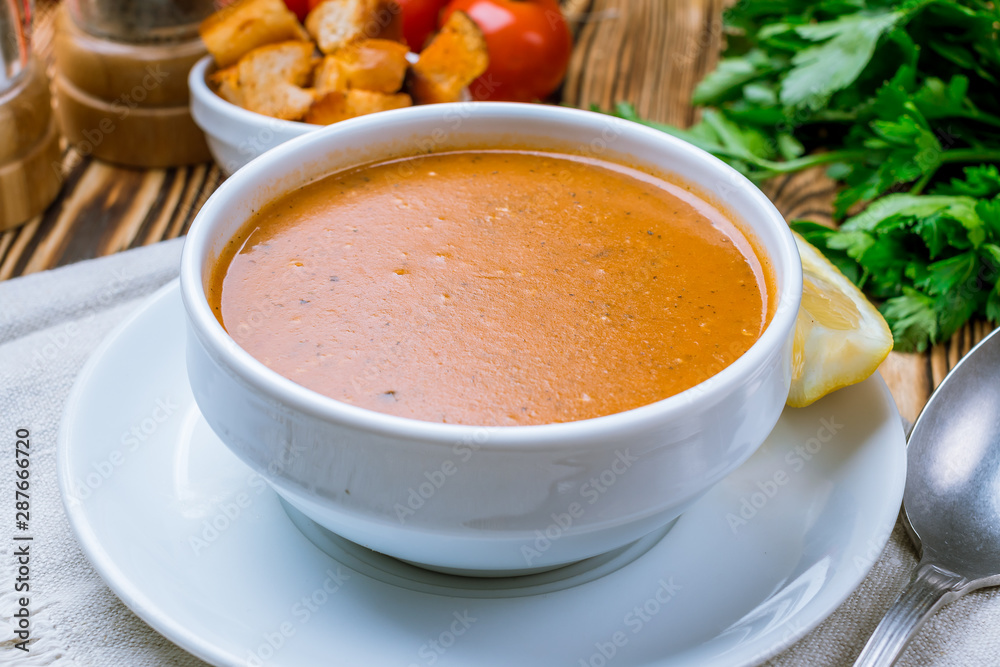 Lentil soup with lemon on wooden table. Turkish cuisine Lentil soup with lemon on wooden table. Turkish cuisine