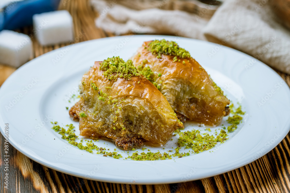 baklava sobiet with pistachios on wooden table. Turkish cuisine