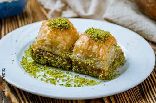 baklava with pistachios on wooden table. Turkish cuisine photo