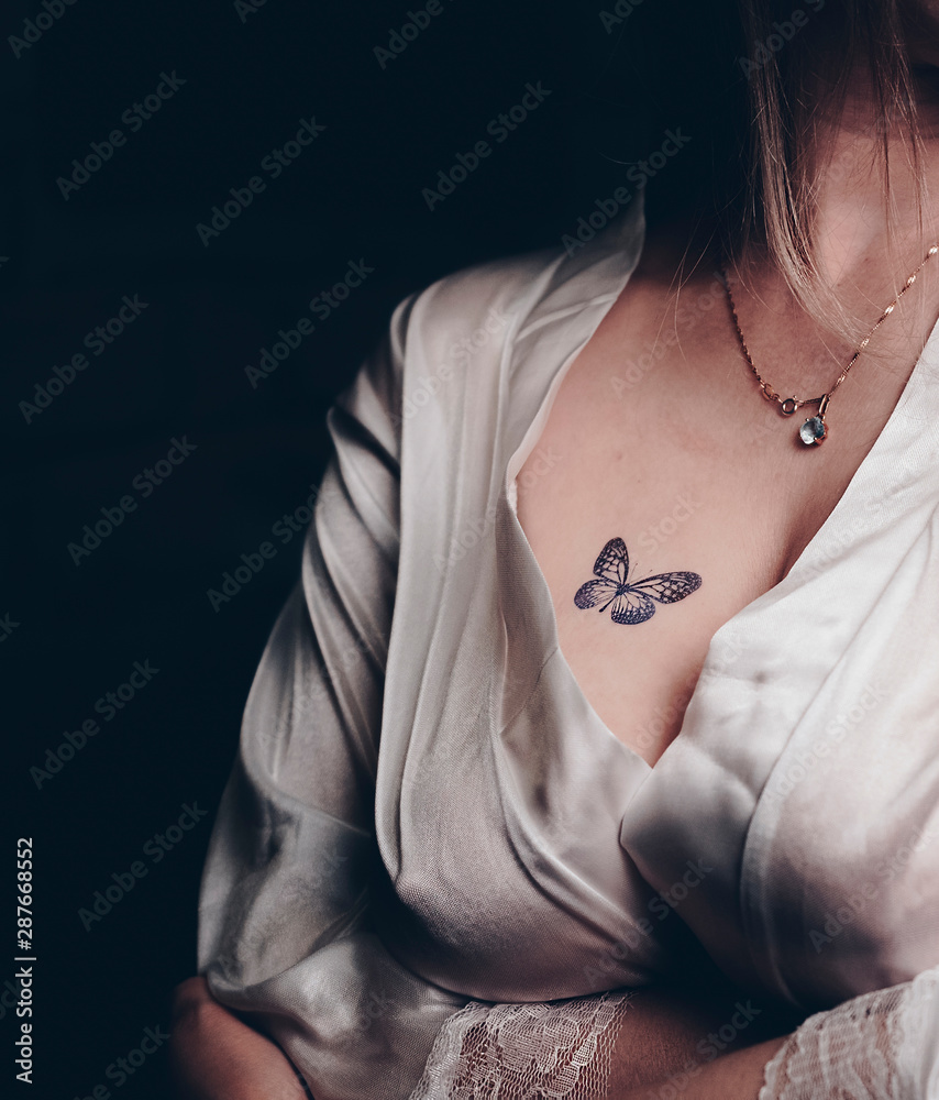 Photo of a beautiful female breast with a butterfly tattoo Stock ...