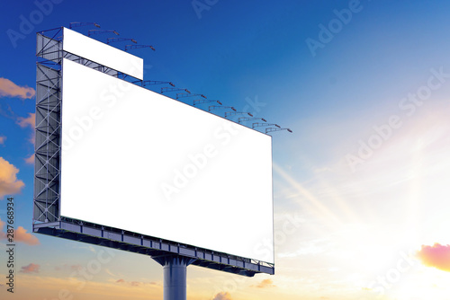 Blank billboard mockup with white screen against clouds and sunset with sunlight background. Copy space banner for advertisement. Business Concept.