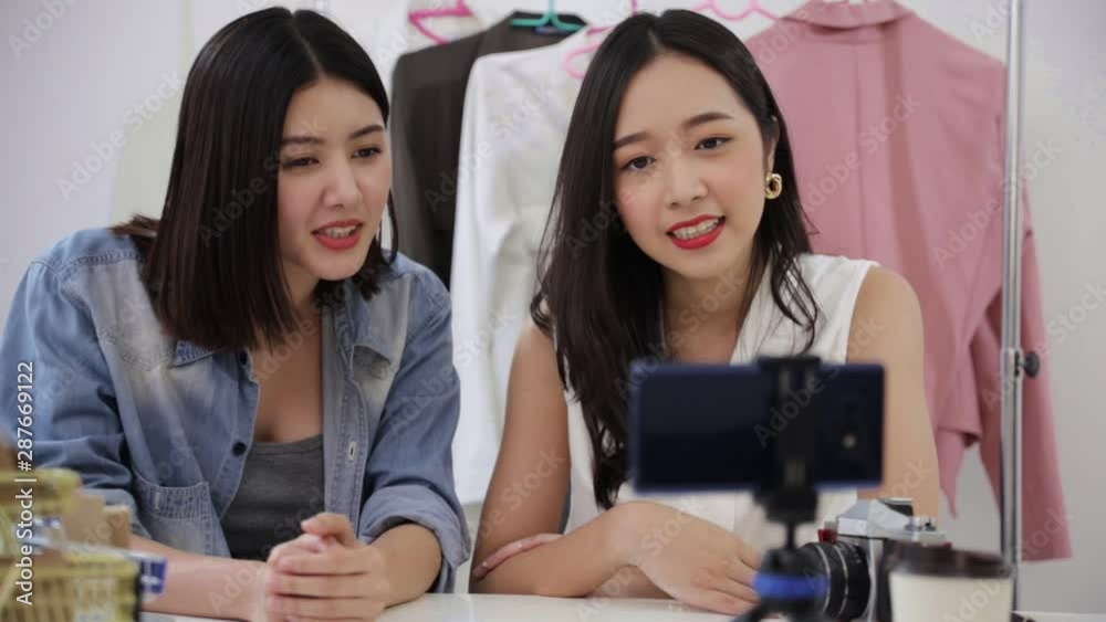 Young asian attractive woman vloggers working as fashion blogger on internet recording video for blog by cellphone at home. Female vlogger showing introducing selling online shop in live streaming.