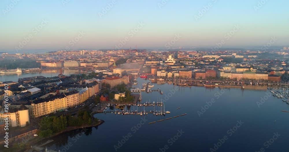 Helsinki north harbor, Aerial, reverse, drone shot, of the Katajannokka and kruunuhaka cityscape, at sunrise, on a foggy, morning dawn, in Helsingfors, Uusimaa, Finland Helsinki north harbor, Aerial, reverse, drone shot, of the Katajannokka and kruunuhaka cityscape, at sunrise, on a foggy, morning dawn, in Helsingfors, Uusimaa, Finland