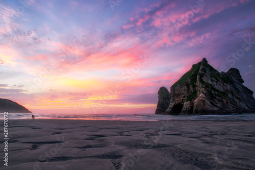 Dramatic colourful sunset skies at Wharariki Beach in Nelson New Zealand