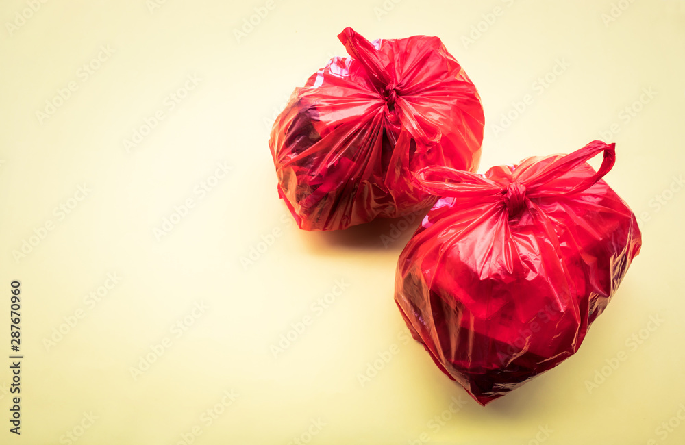 Food trash packing in red plastic bag on color background. Recycle and environment Food trash packing in red plastic bag on color background. Recycle and environment