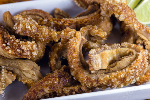 Traditional Brazilian recipe for pork crackling called pork crackling. Traditional Brazilian food, fried and crispy pork. photo