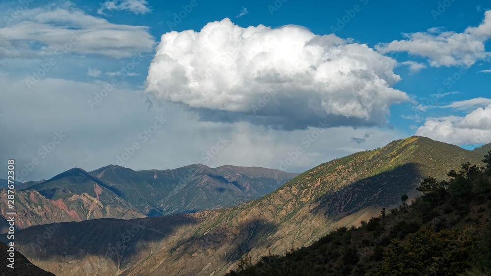 Fototapeta premium Big white clouds over mountains, rain clouds.