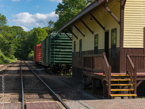 Old railway station with coloured wagons and single track