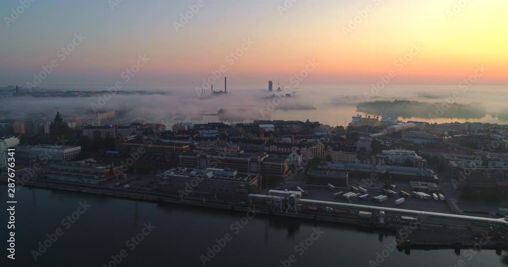 Helsinki foggy dusk, Aerial, tracking, drone shot, of Katajanokka, korkeasaari,tervasaari and fog clouds and colorful sky, at the baltic sea, on a sunny and autumn morning, in Helsingfors, Finland Helsinki foggy dusk, Aerial, tracking, drone shot, of Katajanokka, korkeasaari,tervasaari and fog clouds and colorful sky, at the baltic sea, on a sunny and autumn morning, in Helsingfors, Finland