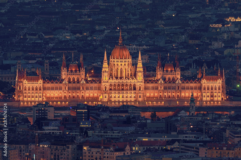 Europe, Hugnary, Budapest Hungarian Parliament in the blue hour with house roofs in Budapest.