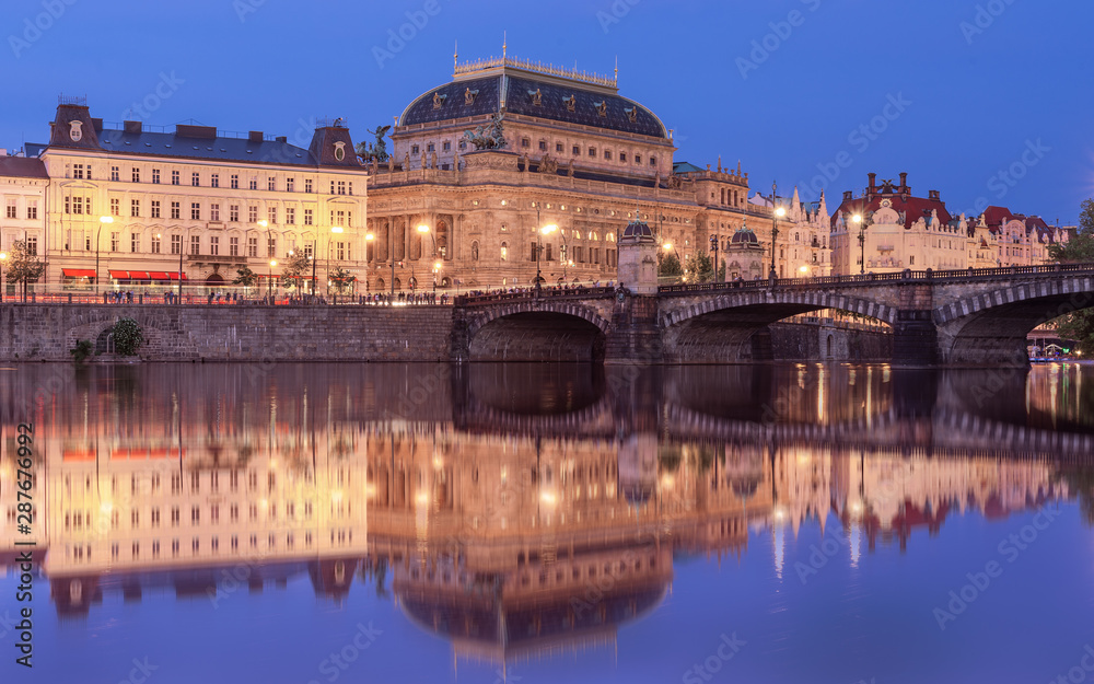 Amazing Prague cityscape with National theatre with reflection from the Kampa island.  Very Popular tourist detination in Eurpoe Beautiful old town, jewish quarter and social life.