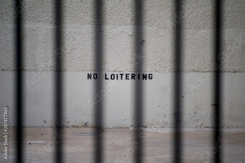 no loitering sign behind black bars