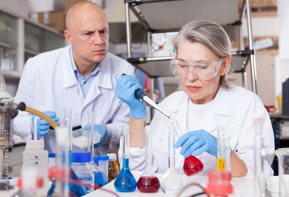 Fototapeta premium Scientists mixing reagents