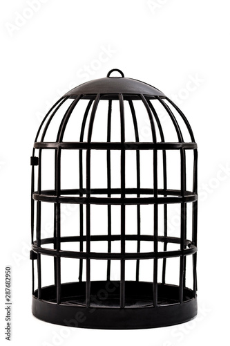 Fototapeta Trapped and captivity conceptual idea with black bird cage isolated on white bac