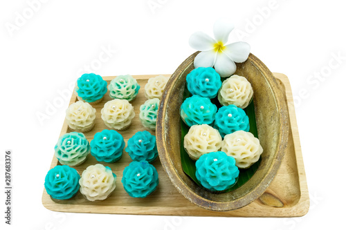 Traditional Thai dessert flower shape stuff with crush soybean and taro (Thai name kanom Chor phaka) in wooden basket on fabric sisal isolated on white background.Saved with clipping path. photo