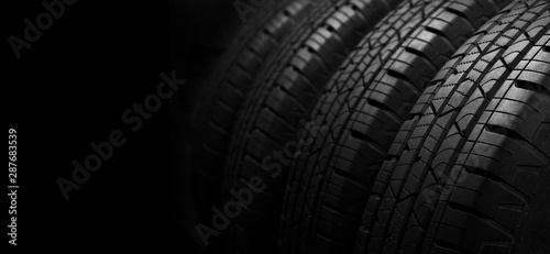 Studio shot of a set of summer car tires on black background with copy space.