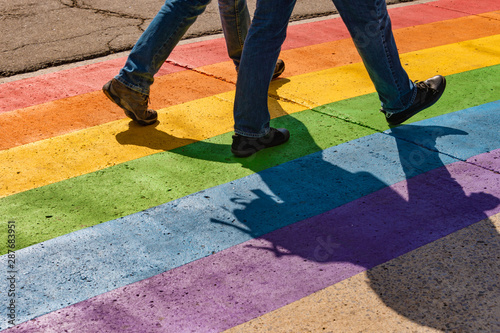 People walking on gay rainbow crosswalk in Montreal