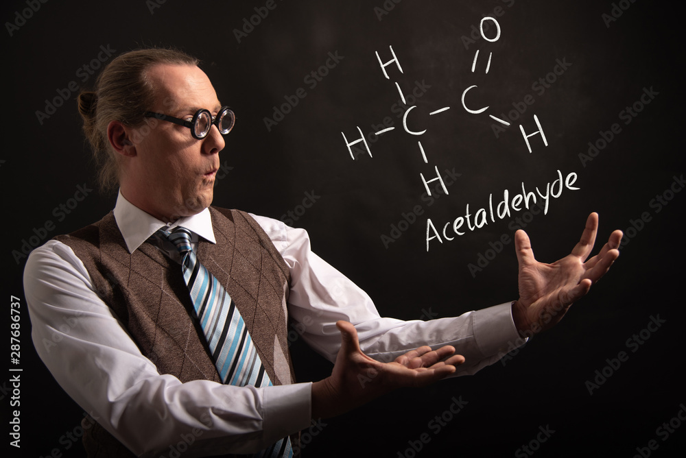 Professor presenting handdrawn chemical formula of acetaldehyde molecule Professor presenting handdrawn chemical formula of acetaldehyde molecule