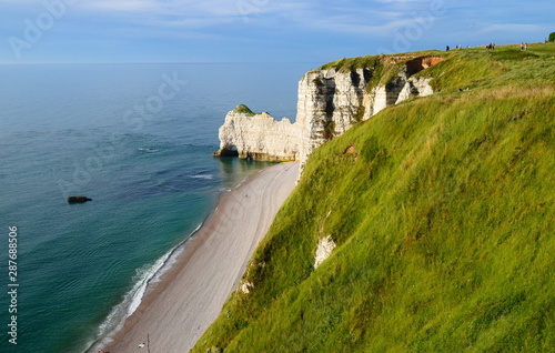 Famous white chalk cliffs of Etretat city in Normandy  France in sunset light