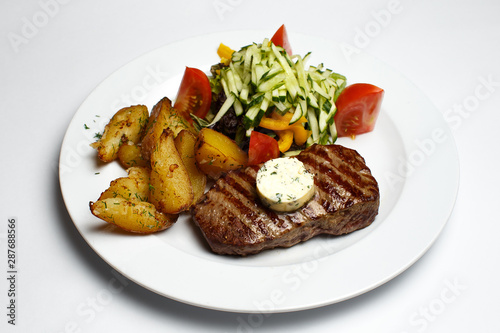 beef steak with potatoes and a vegetables