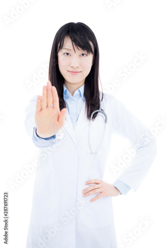 Young female doctor with stethoscope showing STOP gesture isolated on white background