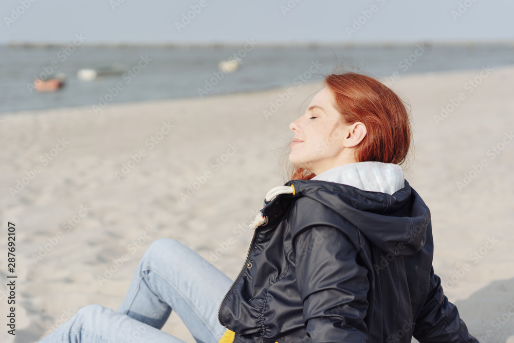 Young woman enjoying the warmth of autumn sunshine Young woman enjoying the warmth of autumn sunshine