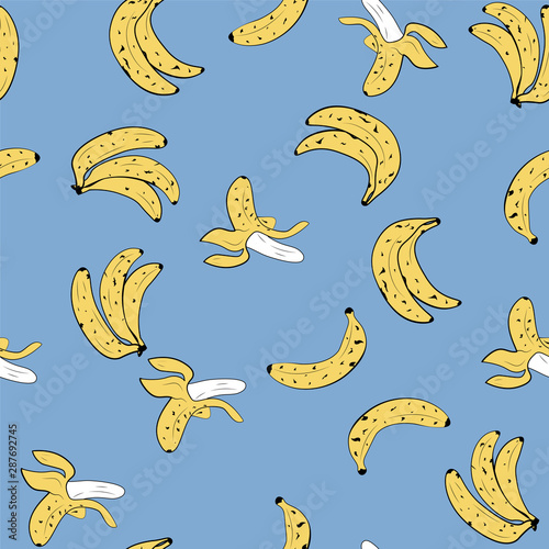 Seamless vector pop art style pattern of bananas randomly distributed on blue background