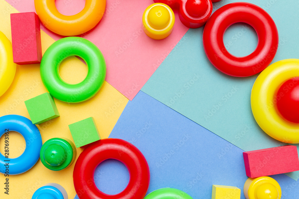 Fototapeta premium Colorful child kid’s education toys pattern background copy space on the bright background. Childhood infancy children babies concept