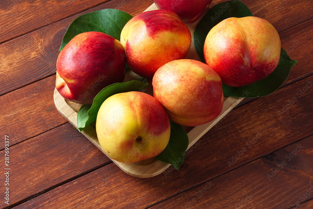 Fresh sweet nectarines on the wooden table Fresh sweet nectarines on the wooden table
