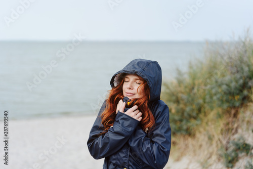 Young woman snuggling into a warm anorak