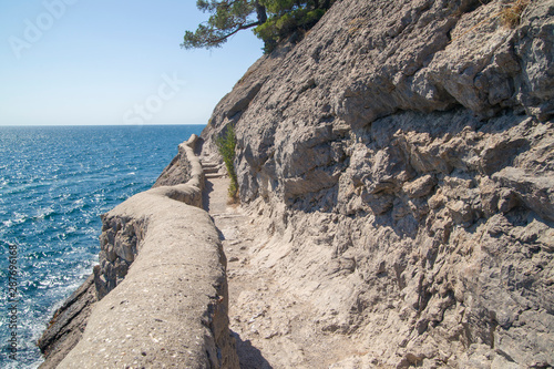 man-made mountain trail in the rock. A popular excursion route. Crimea, Novy Svet.