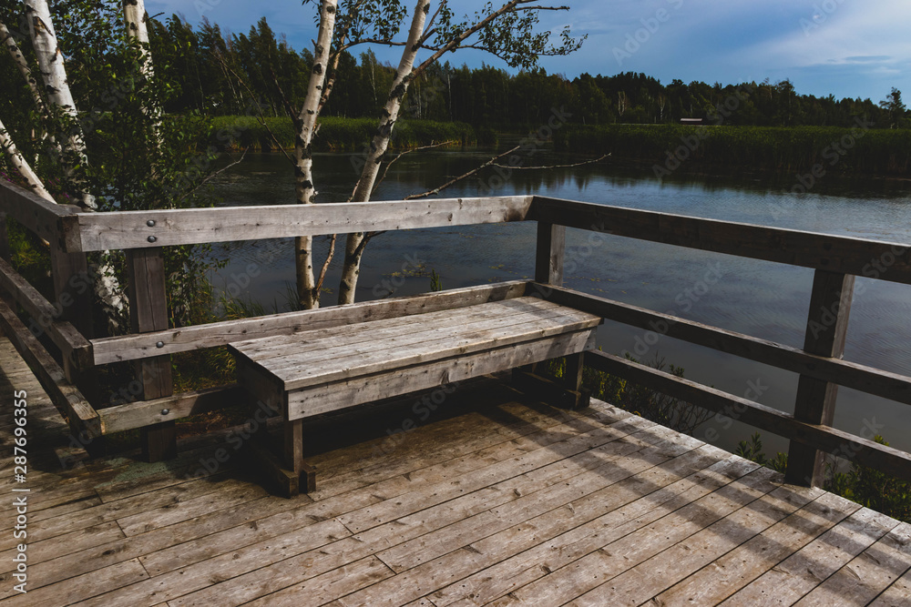 Fototapeta premium wooden bench overlooking water