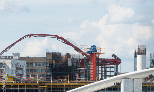 Construction site with cranes on the background of the day sky