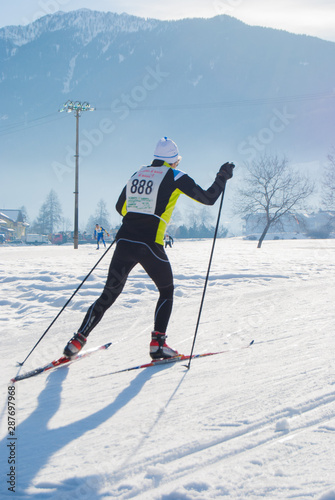 Isolated athlete during an amateur cross country ski race in a sunny day