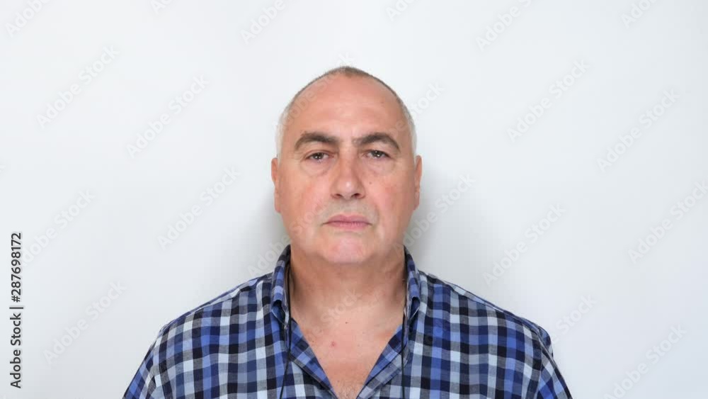 Middle aged man looking at camera isolated on white background. Shot in 4K Middle aged man looking at camera isolated on white background. Shot in 4K