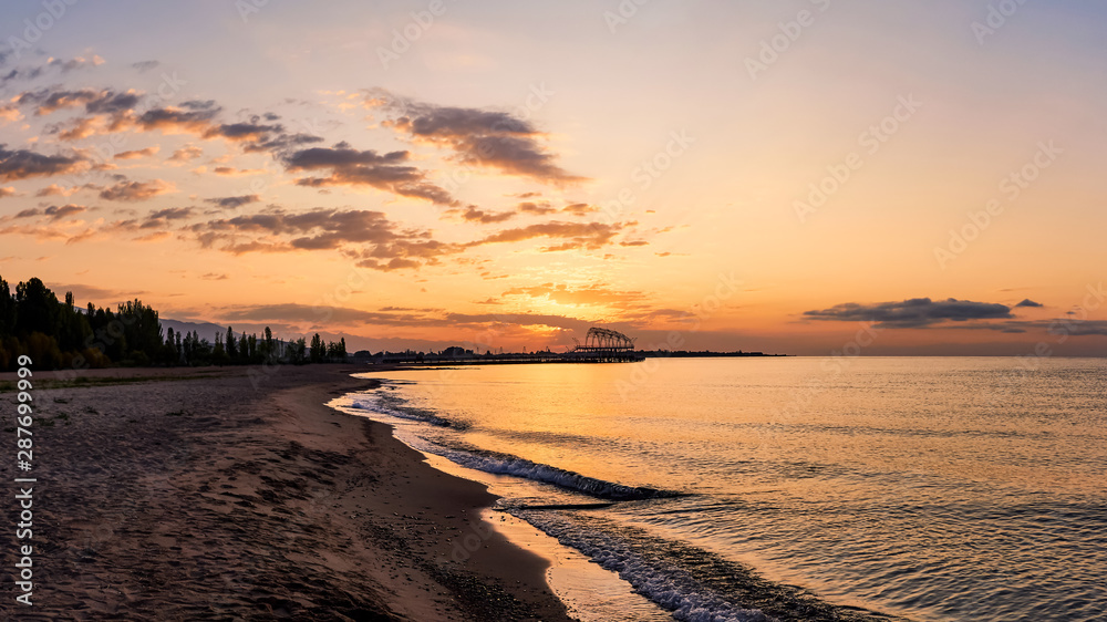 Beautiful panoramic view of the beach at dawn, lit by morning sunlight, luxurious summer adventures, outdoor activities, tourism