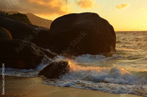 rocky beach of mahe island in the evening