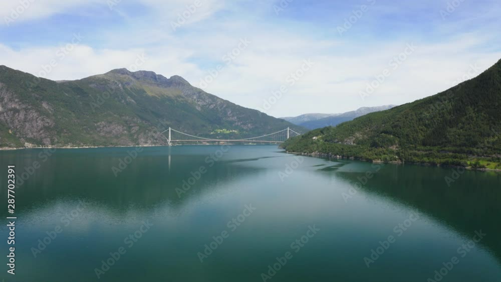 The Hardanger Bridge is a suspension bridge across the Eidfjorden branch of Hardangerfjorden in Hordaland county, Norway. The Hardanger Bridge is a suspension bridge across the Eidfjorden branch of Hardangerfjorden in Hordaland county, Norway.
