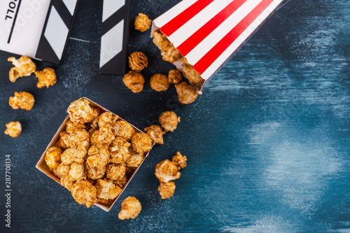 Caramel popcorn and wooden clapper photo