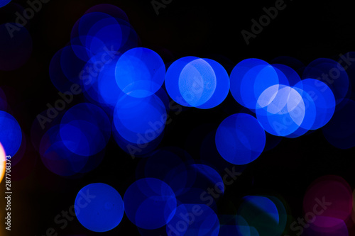 Abstract circular blue light blurred bokeh on dark background