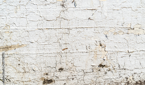 Cracked white paint texture background. Old wood texture with white peeling paint. Different fractures of paint. Background for text or design