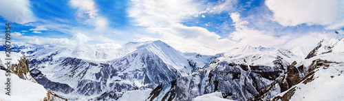 Panorama of snowy mountains. Caucasus mountains, Georgia, view from Gudauri ski resort.
