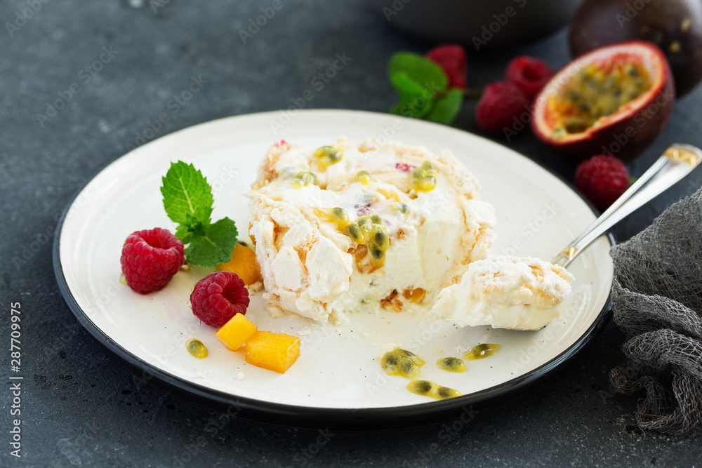 Meringue roulade with raspberries and passion fruit. Pavlova. Dessert. Selective focus Meringue roulade with raspberries and passion fruit. Pavlova. Dessert. Selective focus
