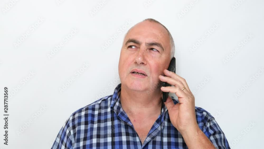 Mature middle aged man using smartphone on white background. Filmed in 4K Mature middle aged man using smartphone on white background. Filmed in 4K