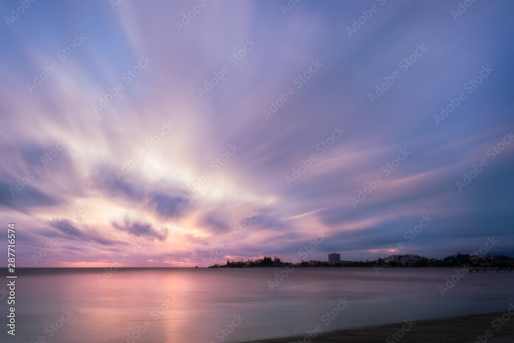 Obraz premium Amazing pastel colors at Sunset at Anse Vata Bay in Noumea, New Caledonia in French Polynesia, South Pacific. Long exposure image .