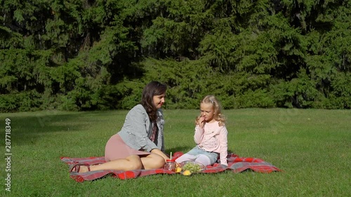 Wallpaper Mural Young Woman and Little Girl Having Picnic with Fresh Fruits in Summer Park. Family, Childhood and People Concept Torontodigital.ca