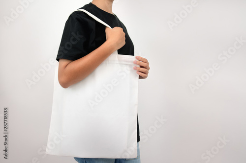 hipter woman holding eco fabric bag isolate on white background photo